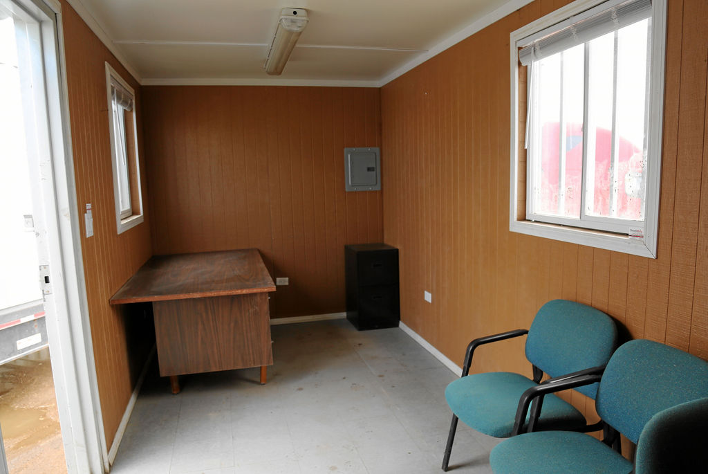 A room with chairs and a desk in it